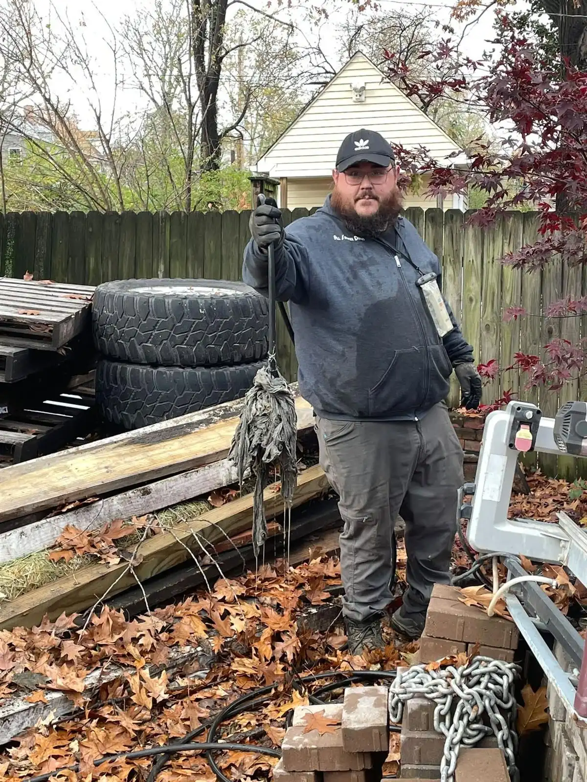 All Service Drain technician Jeff holding what appears to be a mop head removed from a St. Louis sewer main